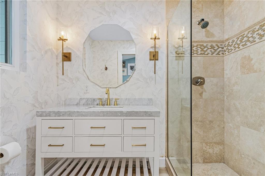 725 2nd Street South Naples, FL 34102 - Photo 18 of 21 a bathroom with a granite countertop sink a mirror and shower