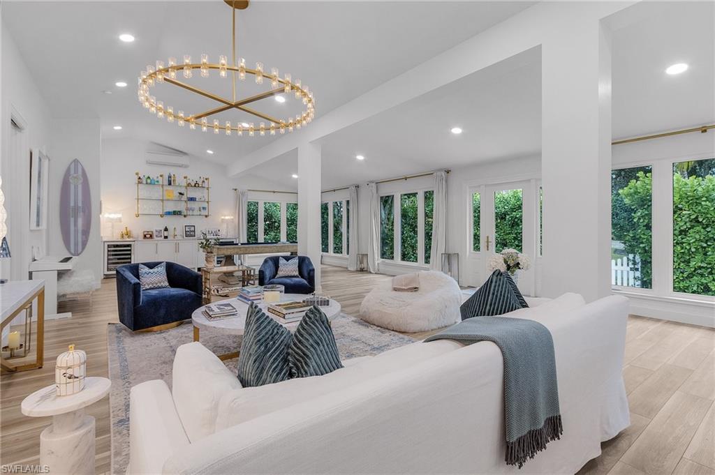 725 2nd Street South Naples, FL 34102 - Photo 4 of 21 a living room with furniture chandelier and large windows