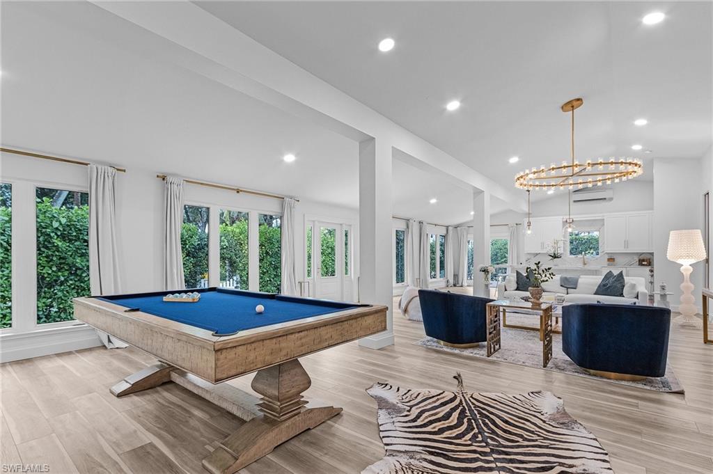 725 2nd Street South Naples, FL 34102 - Photo 7 of 21 a living room with furniture a pool table and a large window