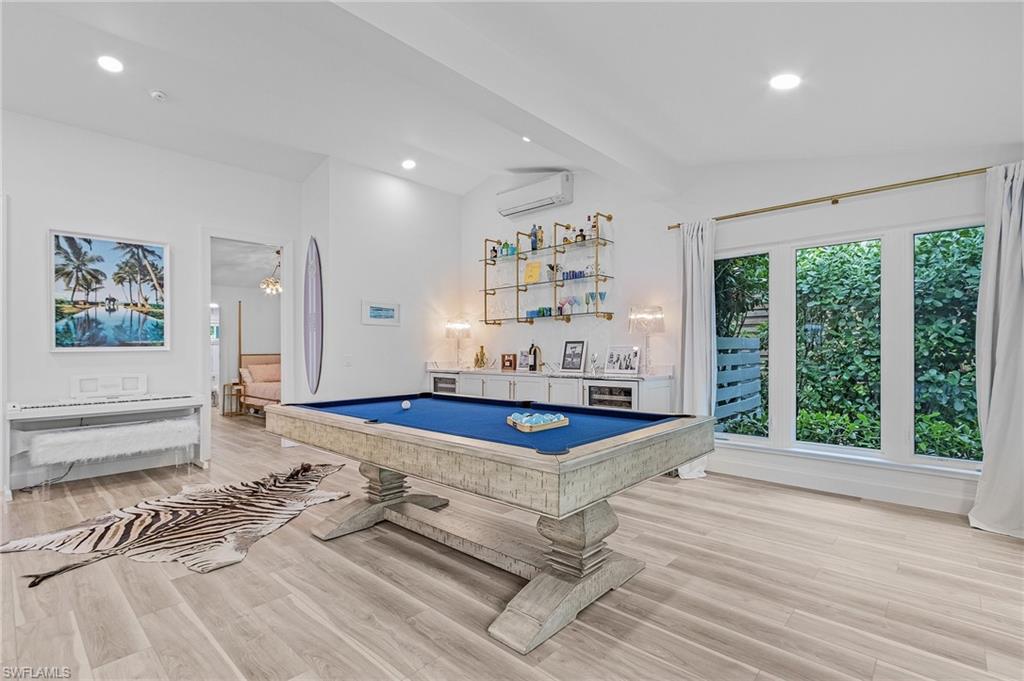 725 2nd Street South Naples, FL 34102 - Photo 8 of 21 a living room with patio furniture and a large window