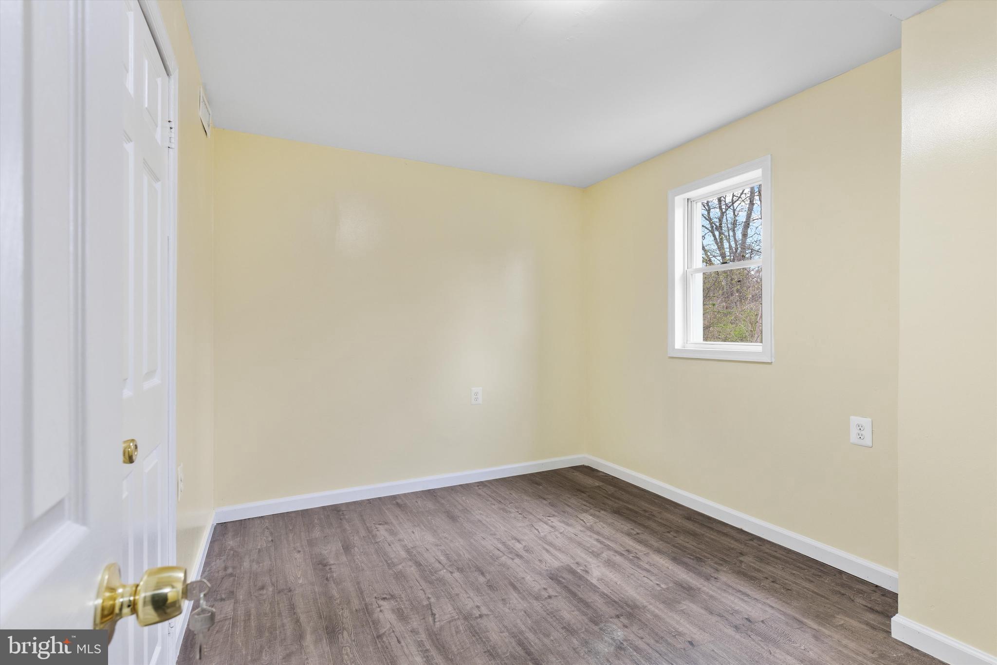 5662 Gunpowder Road White Marsh, MD 21162 - Photo 15 of 37 a view of an empty room with wooden floor and a window