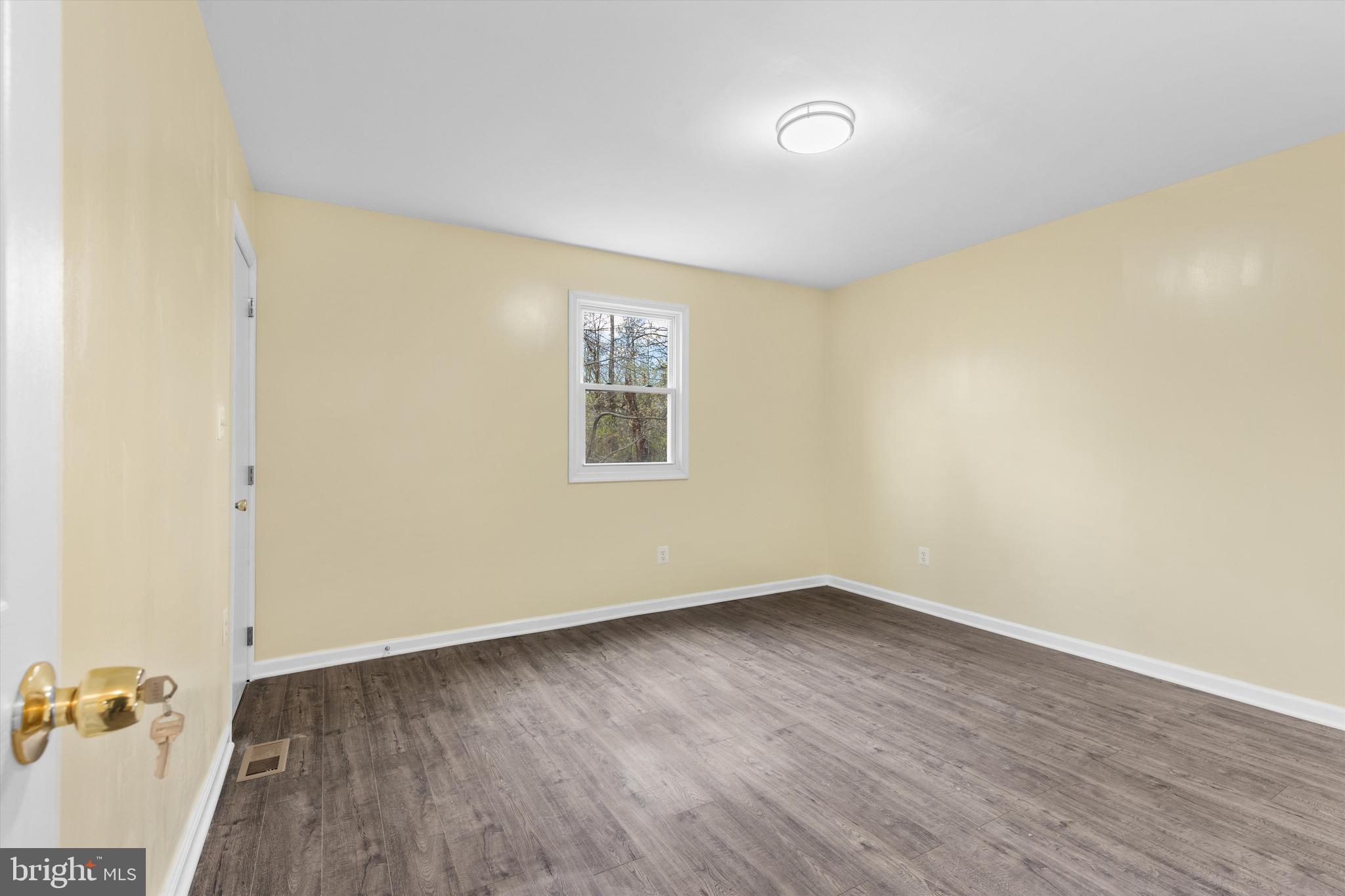 5662 Gunpowder Road White Marsh, MD 21162 - Photo 29 of 37 an empty room with wooden floor and windows