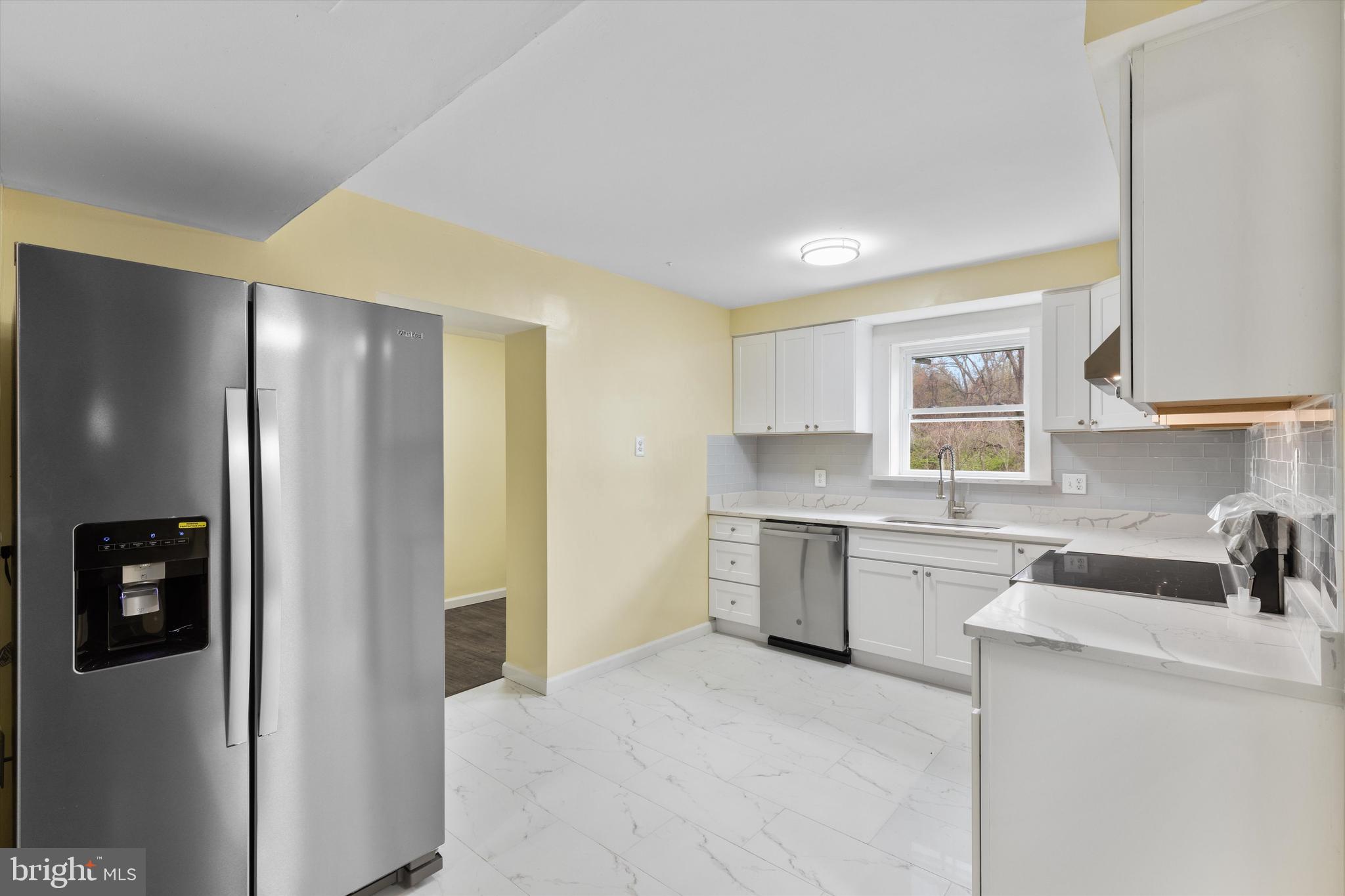 5662 Gunpowder Road White Marsh, MD 21162 - Photo 10 of 37 a kitchen with a refrigerator and a sink