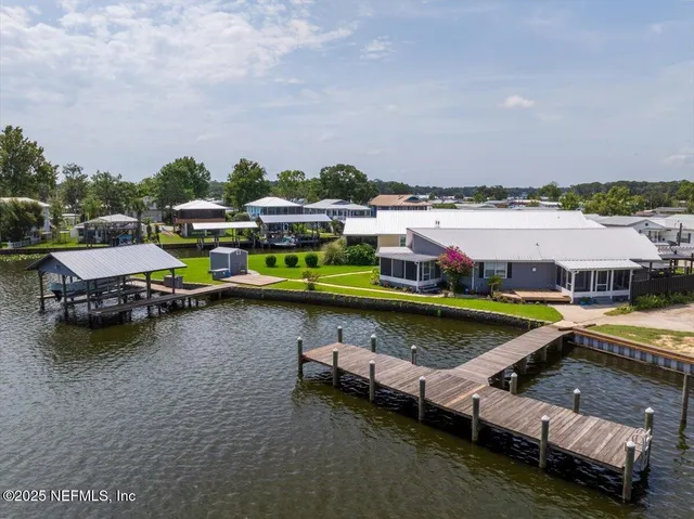a view of a lake with boats and trees in the background
