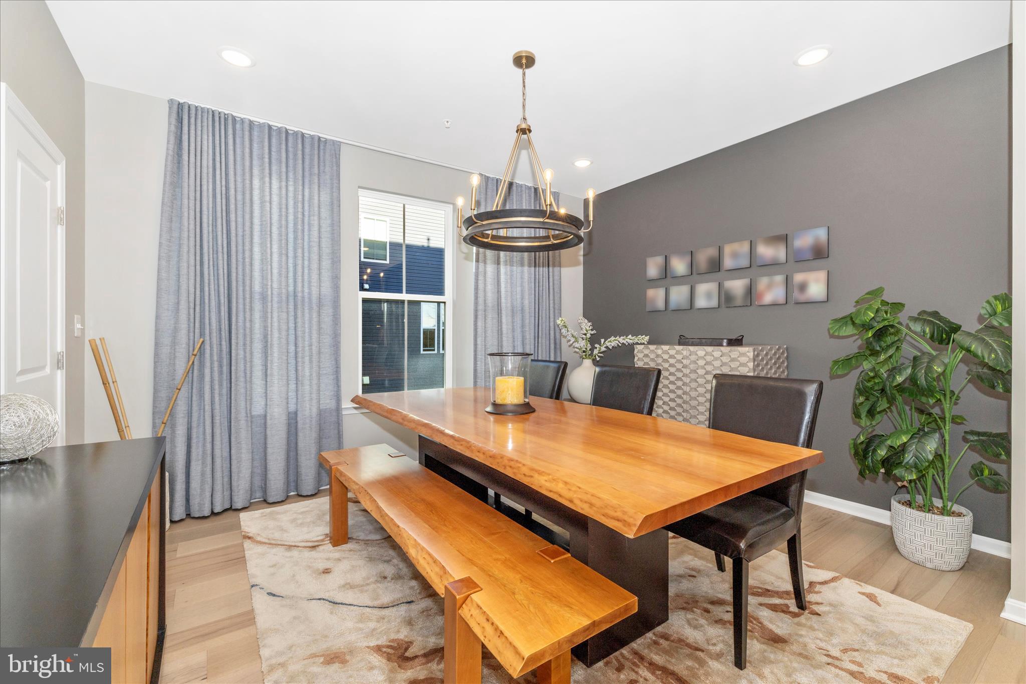 2502 Rucker Lane Frederick, MD 21701 - Photo 13 of 60 a dining room with furniture a chandelier and wooden floor