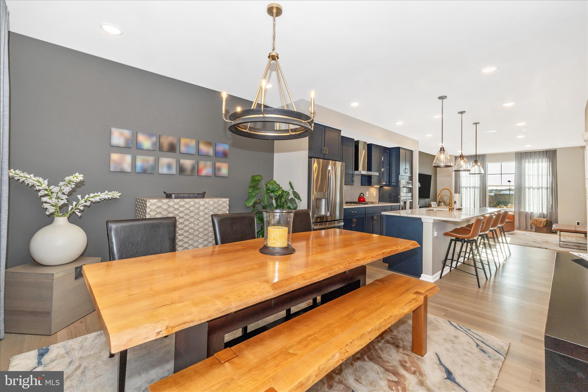 2502 Rucker Lane Frederick, MD 21701 - Photo 17 of 60 a view of a dining room with furniture a chandelier and wooden floor