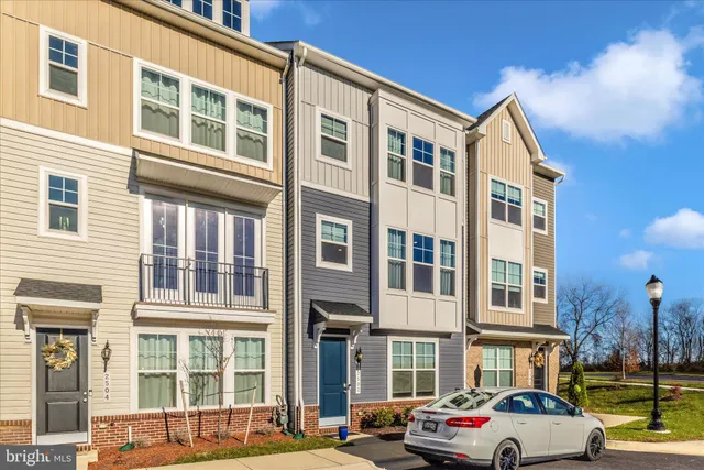 a front view of a residential apartment building with a yard