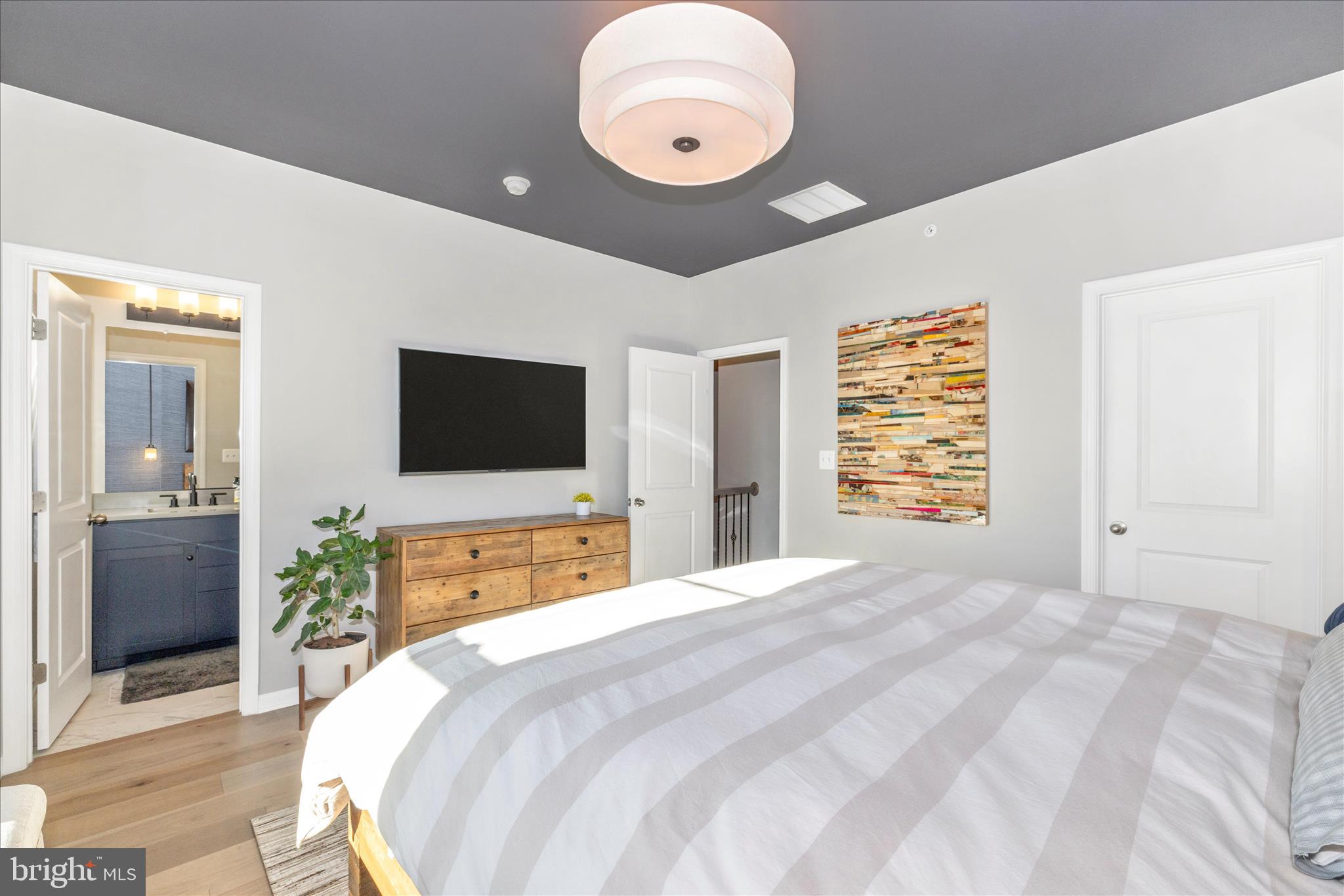 2502 Rucker Lane Frederick, MD 21701 - Photo 34 of 60 a bedroom with a bed and a flat screen tv