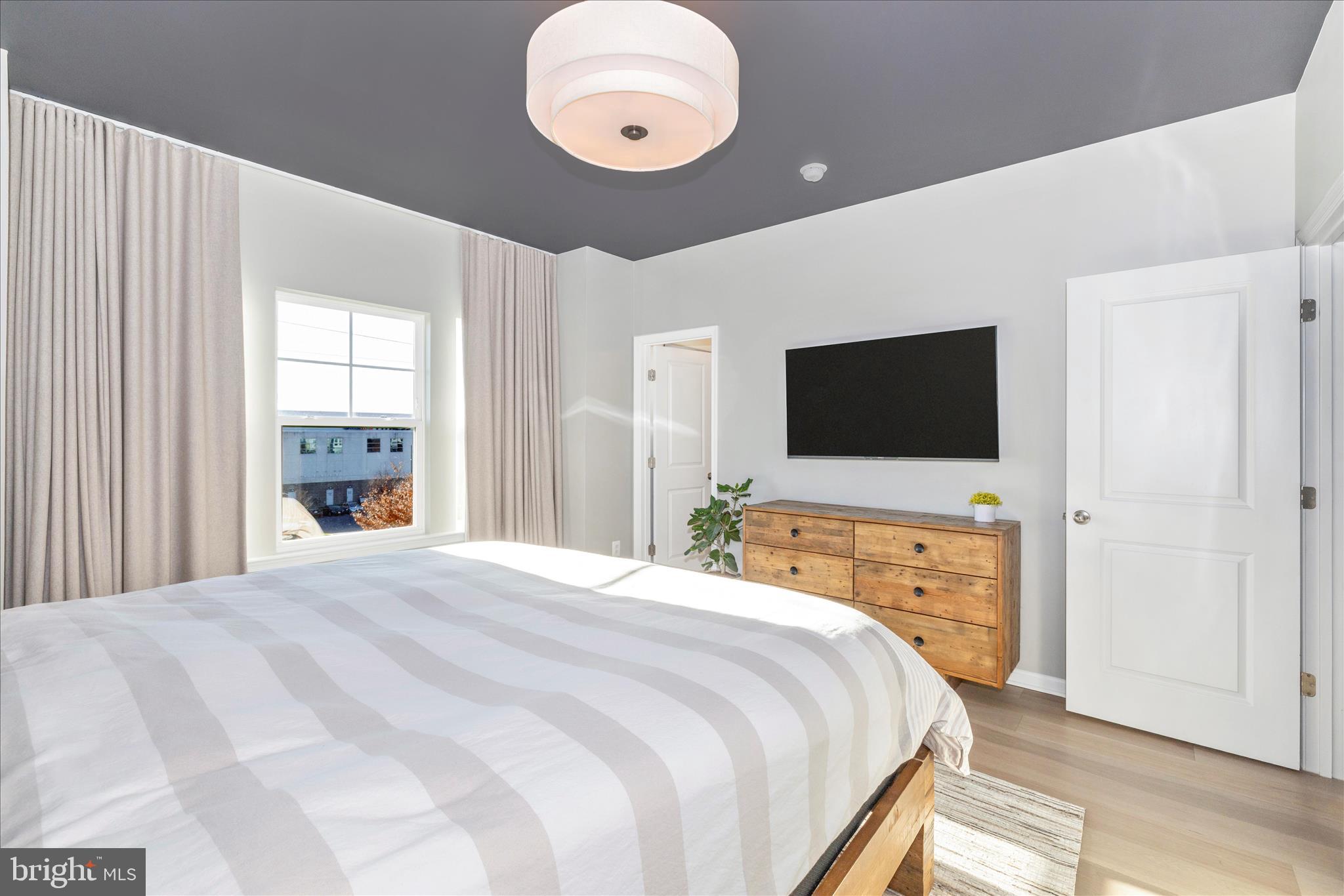 2502 Rucker Lane Frederick, MD 21701 - Photo 35 of 60 a bedroom with a bed and a flat screen tv