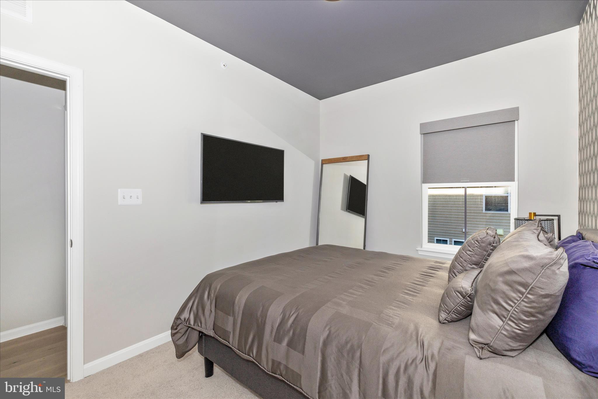 2502 Rucker Lane Frederick, MD 21701 - Photo 44 of 60 a bedroom with a bed and a flat screen tv