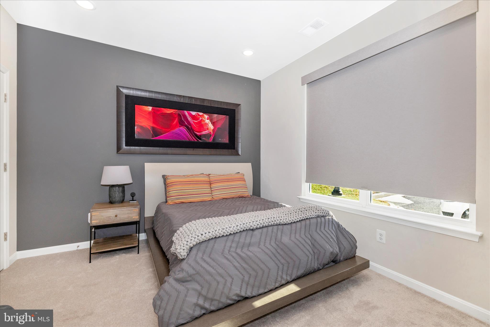 2502 Rucker Lane Frederick, MD 21701 - Photo 8 of 60 a bedroom with a bed and a flat screen tv