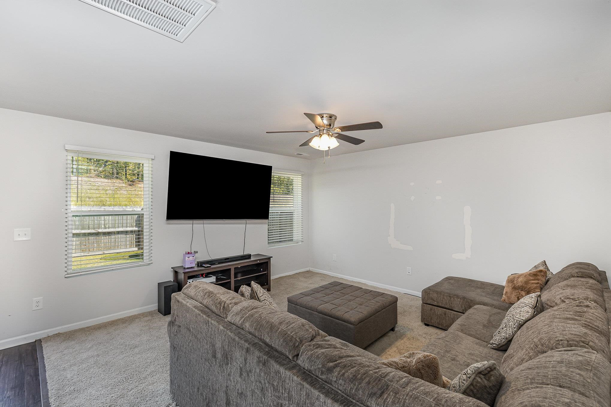 226 Hallow Oak Street Spring Lake, NC 28390 - Photo 11 of 30 a living room with furniture and a flat screen tv