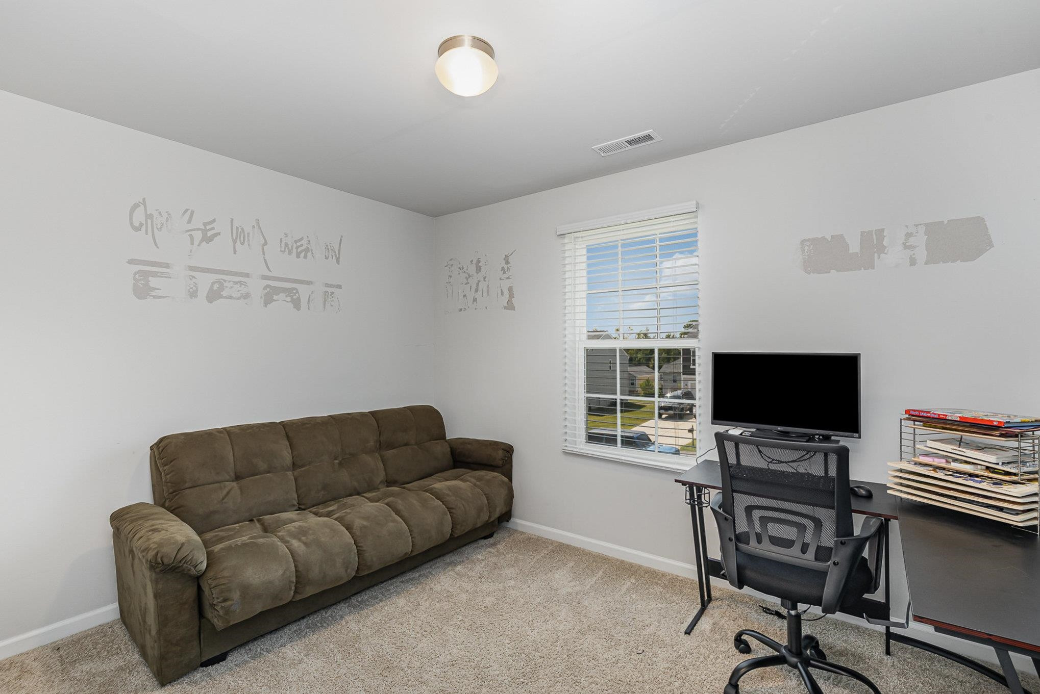 226 Hallow Oak Street Spring Lake, NC 28390 - Photo 12 of 30 a living room with furniture and a flat screen tv