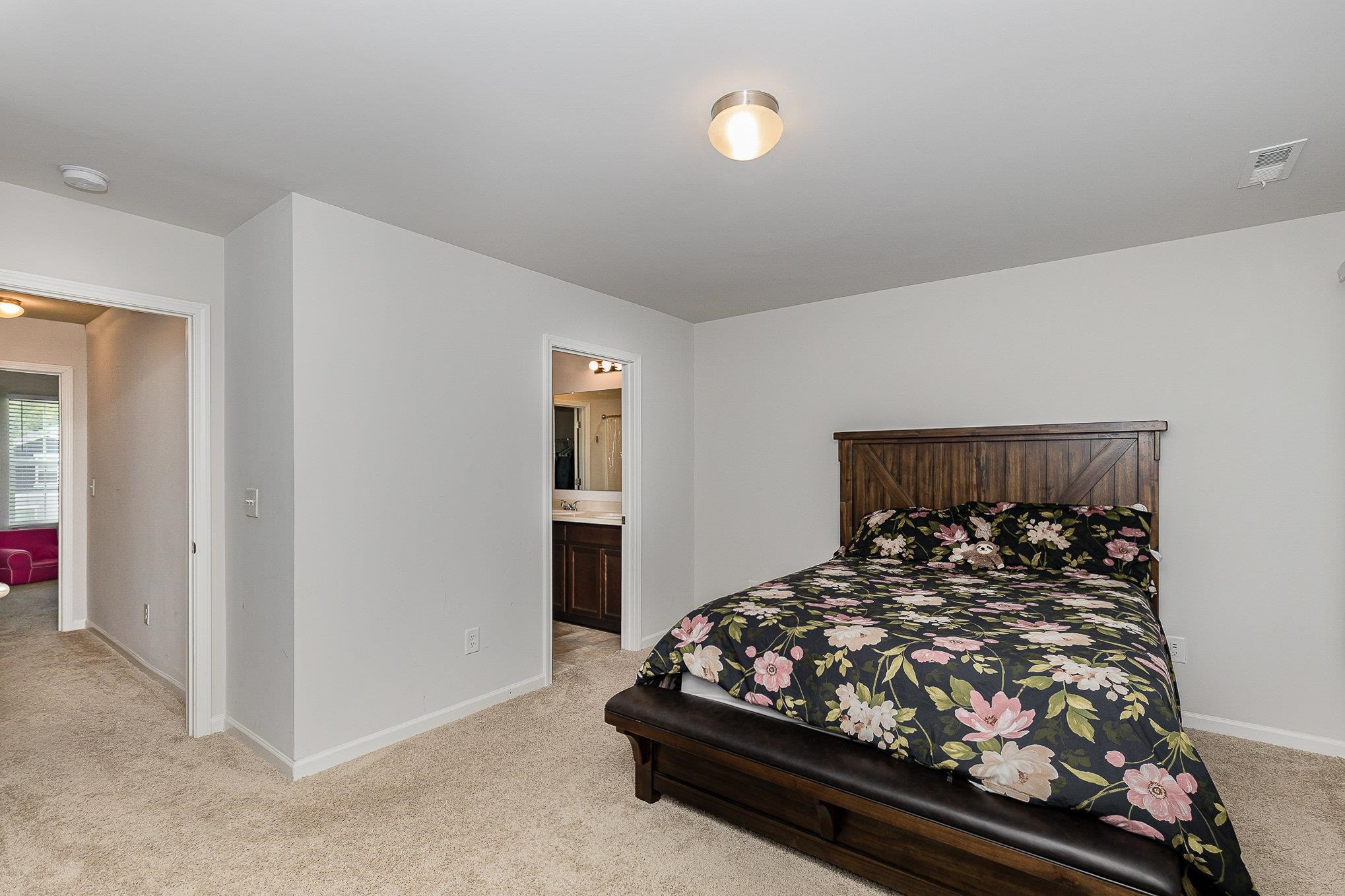 226 Hallow Oak Street Spring Lake, NC 28390 - Photo 18 of 30 a bed sitting in a bedroom next to a window and a larger closet
