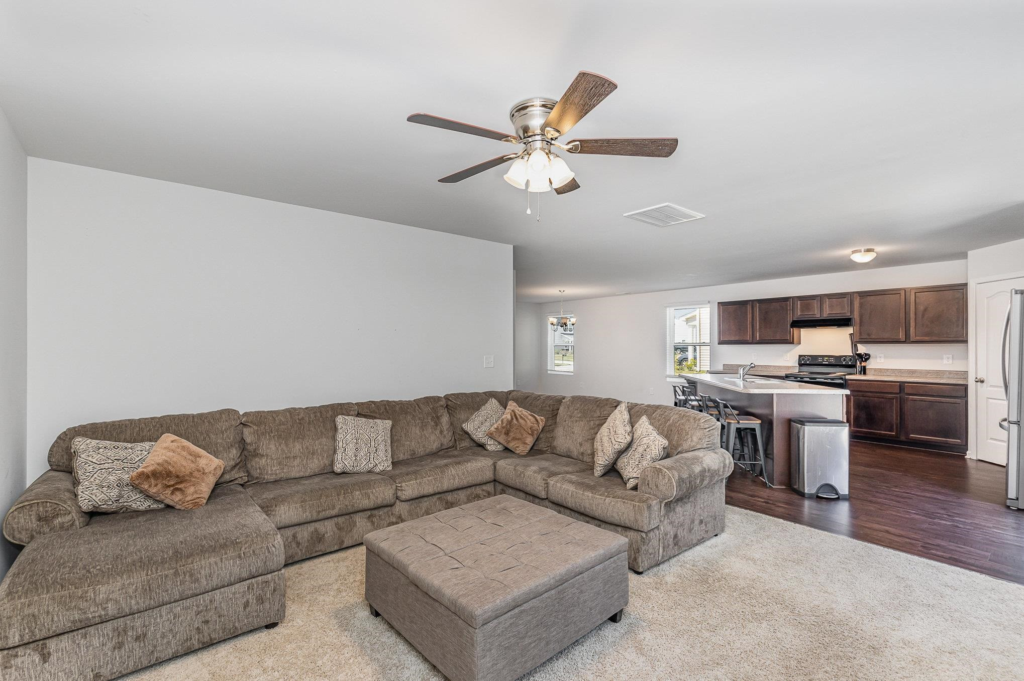 226 Hallow Oak Street Spring Lake, NC 28390 - Photo 23 of 30 a living room with furniture kitchen view and a chandelier