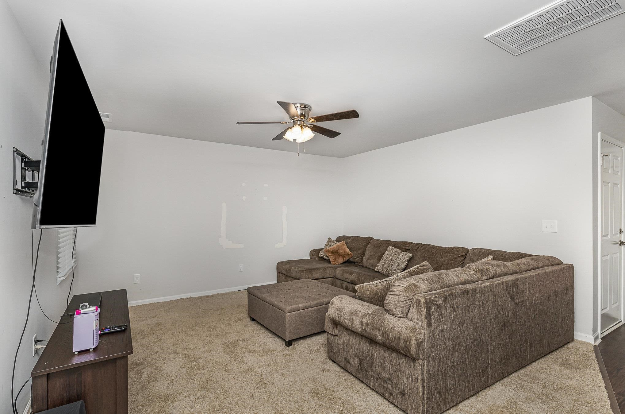 226 Hallow Oak Street Spring Lake, NC 28390 - Photo 24 of 30 a living room with furniture and a flat screen tv