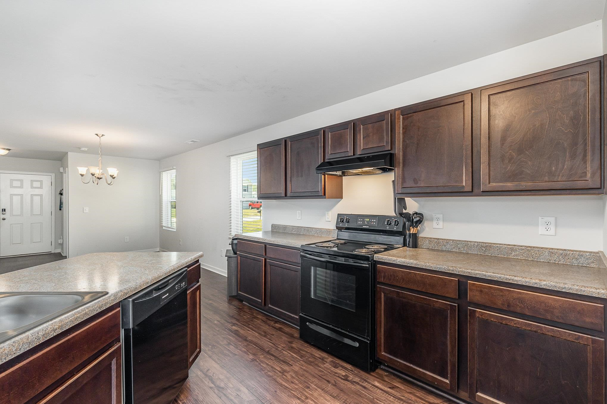 226 Hallow Oak Street Spring Lake, NC 28390 - Photo 25 of 30 a kitchen with stainless steel appliances granite countertop a stove a sink and a microwave