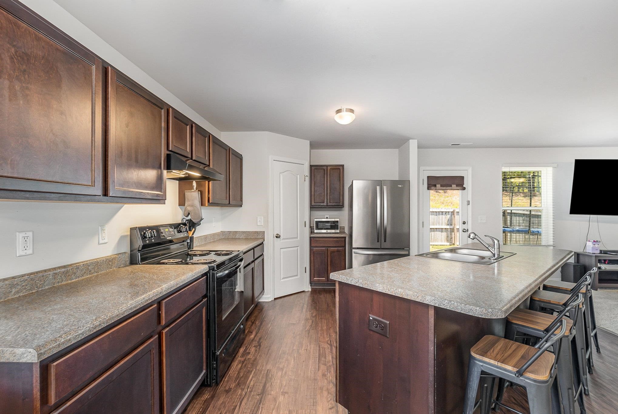 226 Hallow Oak Street Spring Lake, NC 28390 - Photo 26 of 30 a kitchen with stainless steel appliances granite countertop a sink stove and refrigerator