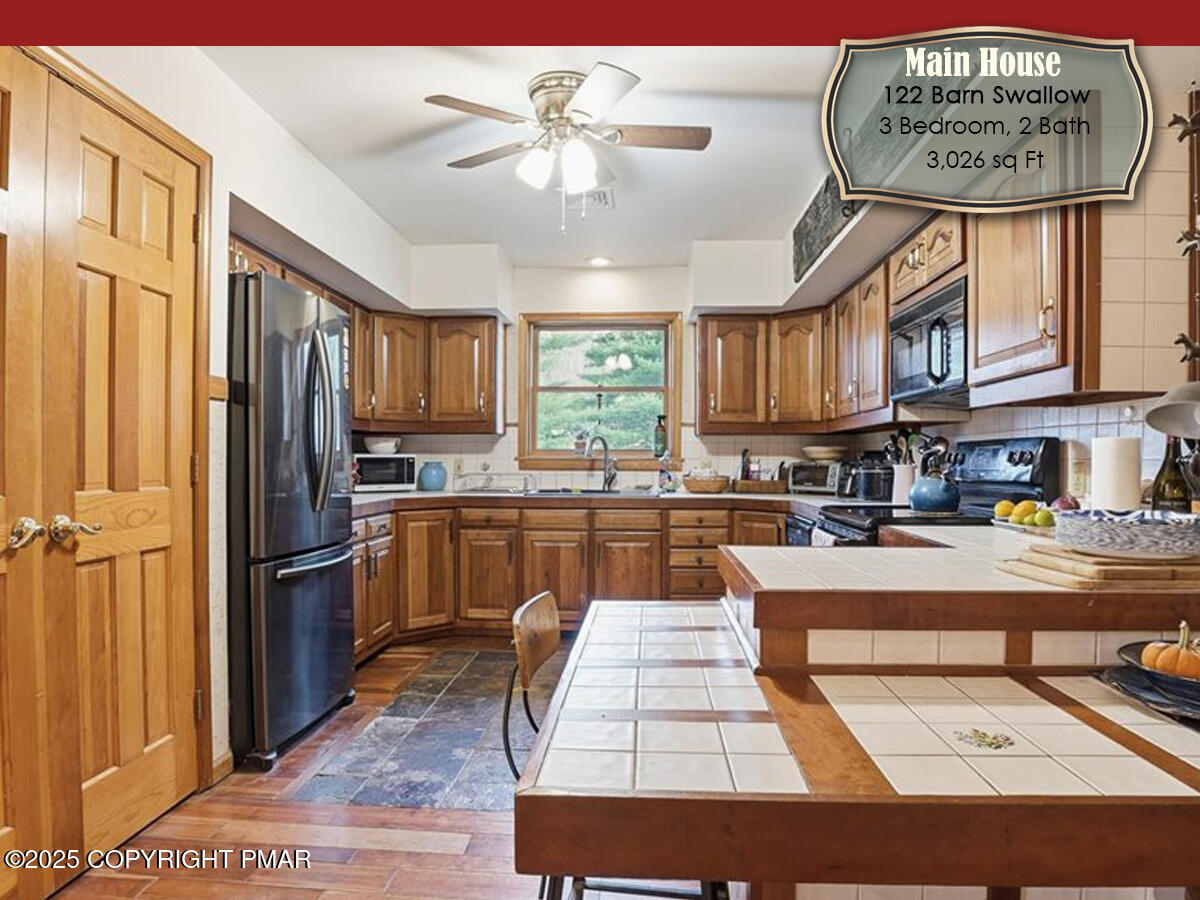 130 Barn Swallow Lane Cresco, PA 18326 - Photo 12 of 75 a kitchen with stainless steel appliances granite countertop a refrigerator a sink dishwasher a stove and white cabinets