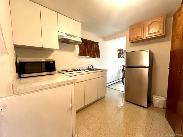 a kitchen with stainless steel appliances a refrigerator and a stove top oven