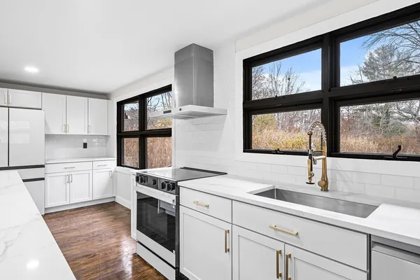 a kitchen that has a sink and a stove