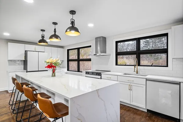 a kitchen with a stove a sink and a refrigerator