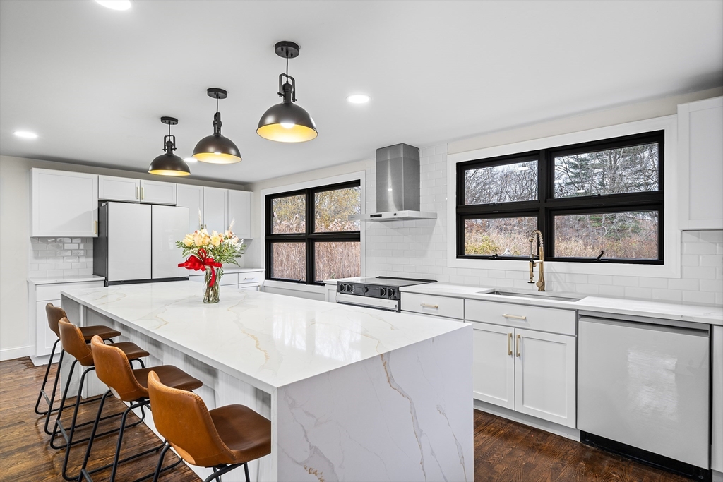 195 Barney Avenue Rehoboth, MA 02769 - Photo 12 of 37 a kitchen with a stove a sink and a refrigerator