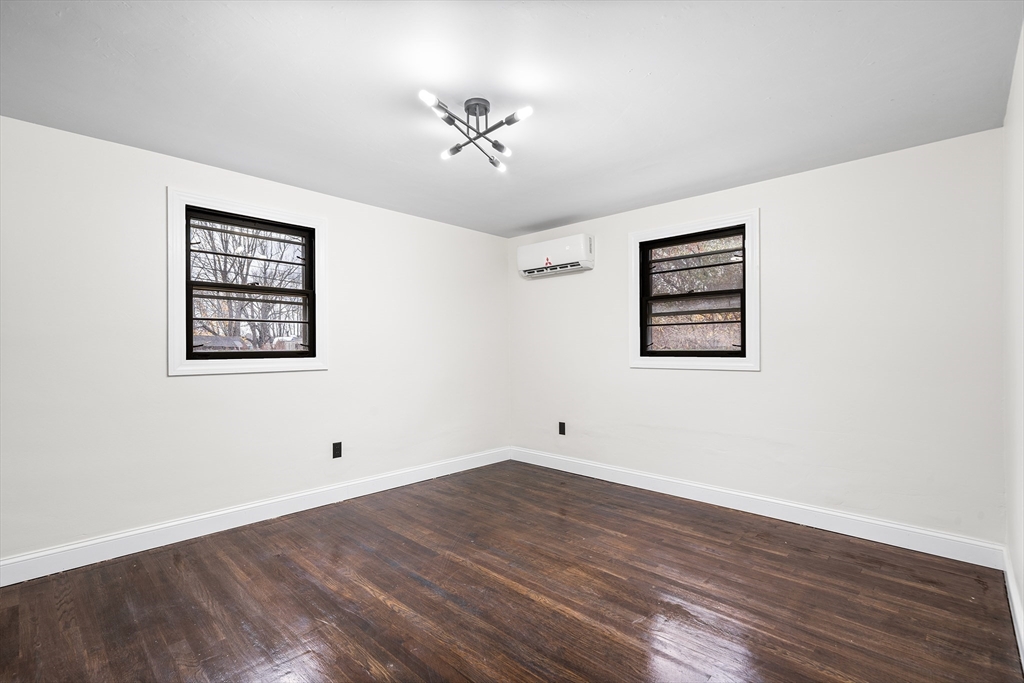 195 Barney Avenue Rehoboth, MA 02769 - Photo 14 of 37 a view of an empty room with wooden floor and a window