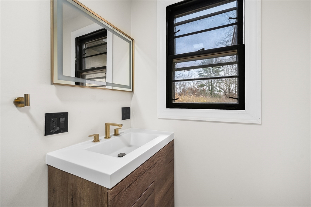 195 Barney Avenue Rehoboth, MA 02769 - Photo 19 of 37 a bathroom with a sink and a mirror
