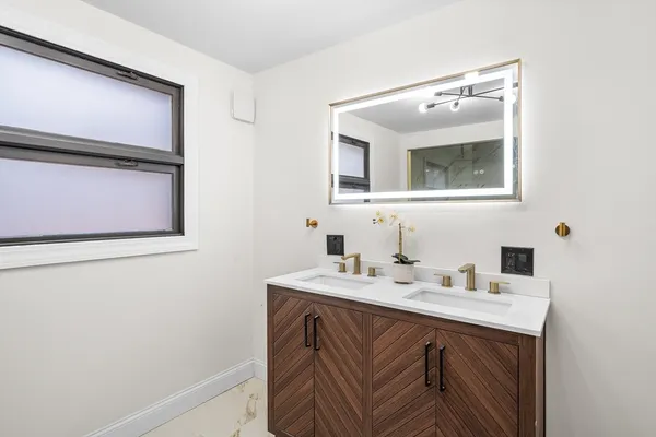 a bathroom with a sink vanity and mirror