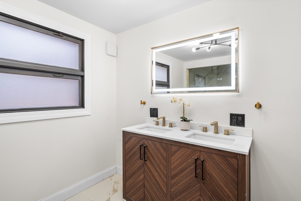 195 Barney Avenue Rehoboth, MA 02769 - Photo 27 of 37 a bathroom with a sink vanity and mirror