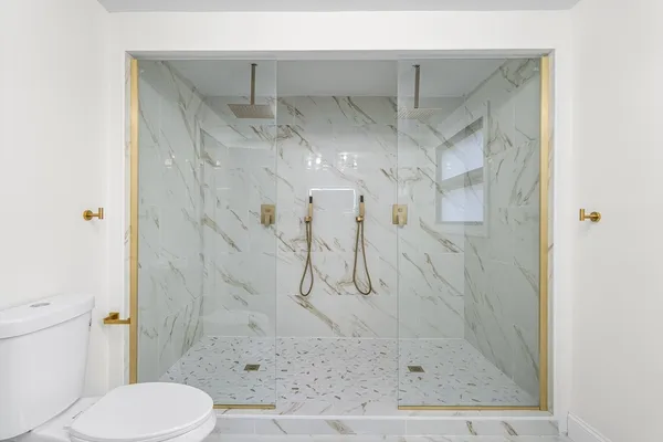 a bathroom with a shower and toilet