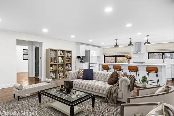 a living room with furniture and wooden floor