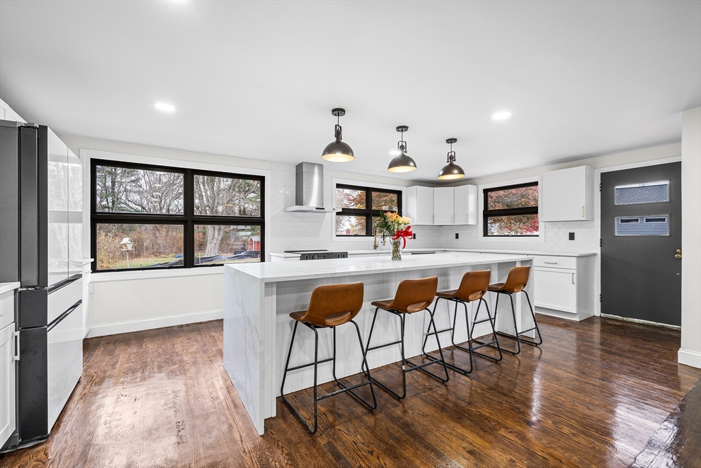 195 Barney Avenue Rehoboth, MA 02769 - Photo 5 of 37 a dining hall with stainless steel appliances kitchen island granite countertop a dining table chairs and view of living room