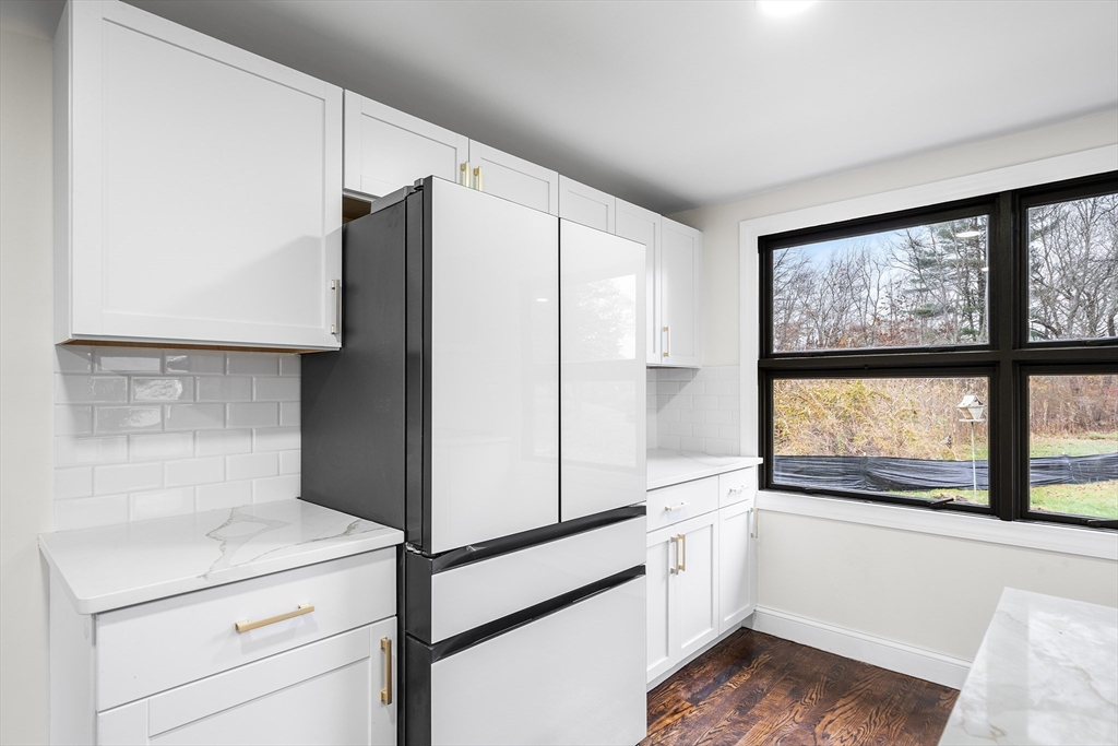 195 Barney Avenue Rehoboth, MA 02769 - Photo 7 of 37 a kitchen with a refrigerator and a large window