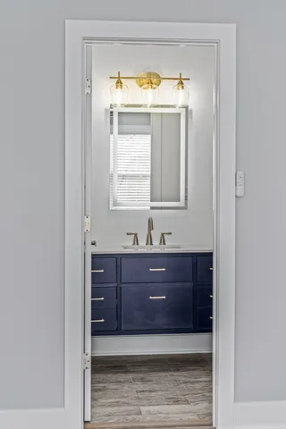 a bathroom with a vanity and a mirror