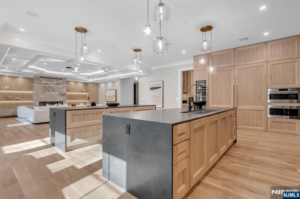 12 Echo Ridge Road Upper Saddle River, NJ 07458 - Photo 16 of 49 a large kitchen with kitchen island a large counter space a sink appliances and cabinets
