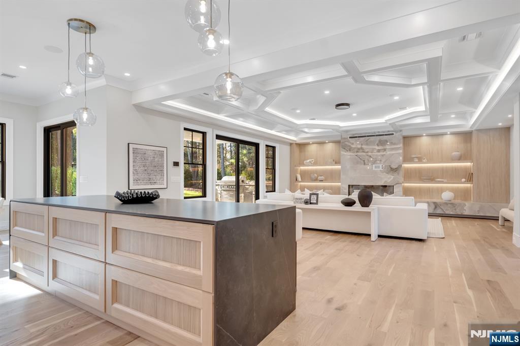 12 Echo Ridge Road Upper Saddle River, NJ 07458 - Photo 17 of 49 a large living room with kitchen island furniture and a chandelier