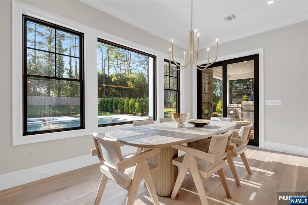 12 Echo Ridge Road Upper Saddle River, NJ 07458 - Photo 20 of 49 a view of a dining room with furniture large windows and wooden floor