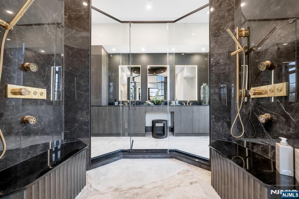 12 Echo Ridge Road Upper Saddle River, NJ 07458 - Photo 31 of 49 a bathroom with a tub a sink and mirrors