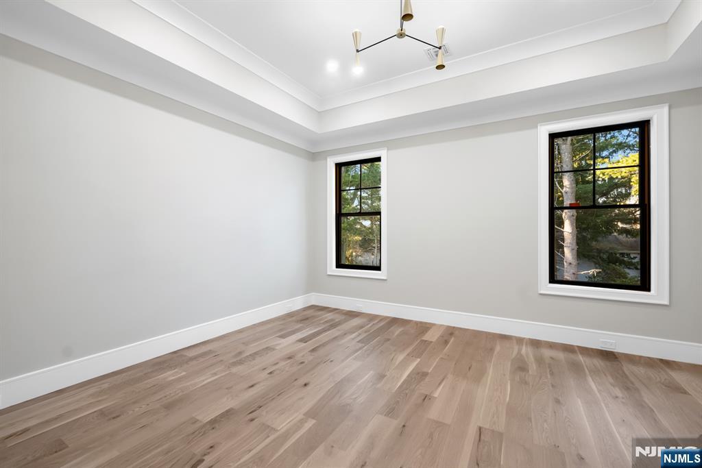 12 Echo Ridge Road Upper Saddle River, NJ 07458 - Photo 38 of 49 a view of an empty room with wooden floor and a window