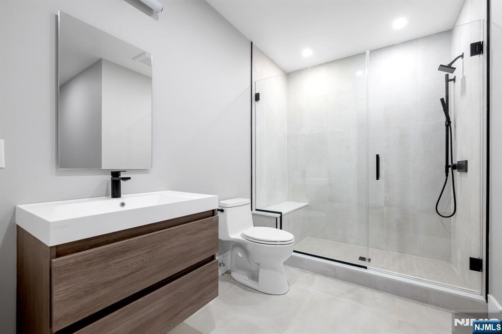 12 Echo Ridge Road Upper Saddle River, NJ 07458 - Photo 42 of 49 a bathroom with a shower sink vanity and toilet