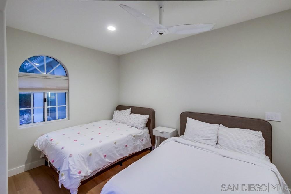 4124 Stonebridge Lane Rancho Santa Fe, CA 92091 - Photo 23 of 38 a bedroom with two beds and painted walls