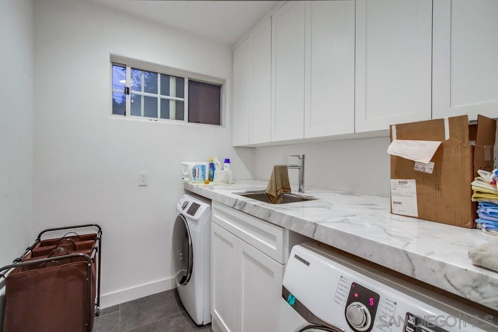 4124 Stonebridge Lane Rancho Santa Fe, CA 92091 - Photo 28 of 38 a utility room with sink dryer and washer