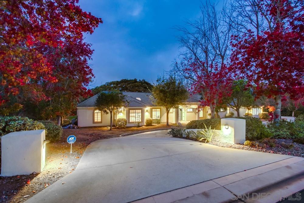 4124 Stonebridge Lane Rancho Santa Fe, CA 92091 - Photo 3 of 38 a front view of a house with a yard and garage