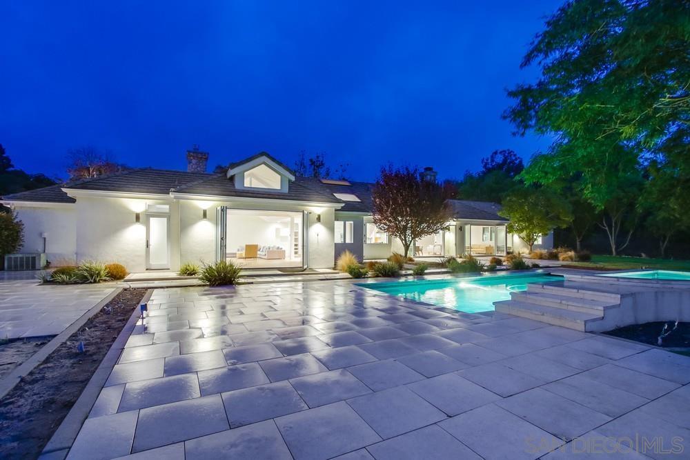4124 Stonebridge Lane Rancho Santa Fe, CA 92091 - Photo 32 of 38 a view of a house with a yard and a large tree