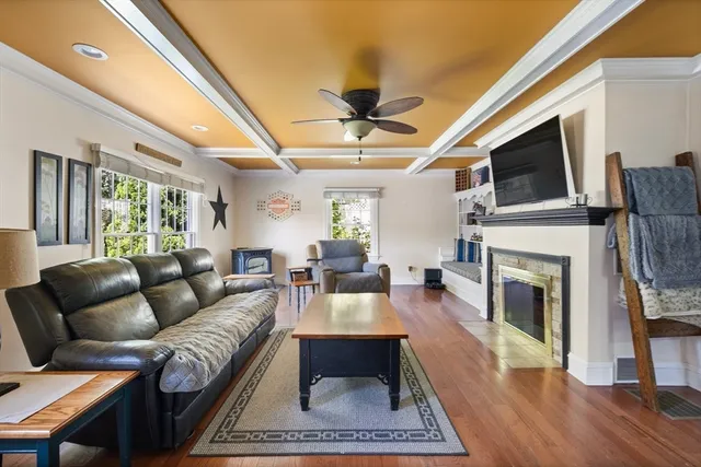 a living room with furniture a flat screen tv and a fireplace