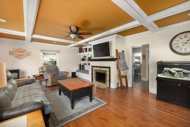 a living room with furniture a fireplace and a flat screen tv