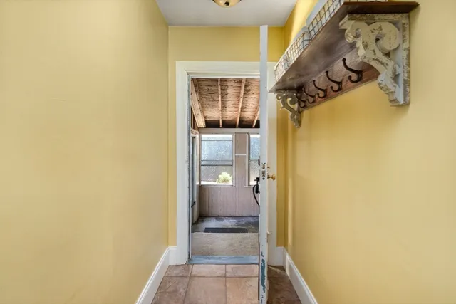 a view of a hallway with wooden shelves