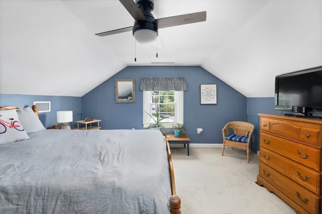 a bedroom with furniture and a flat screen tv